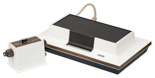 The Magnavox Odyssey, a black and white box with a controller
	attached to it.