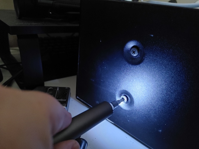 A screwdriver unscrewing.